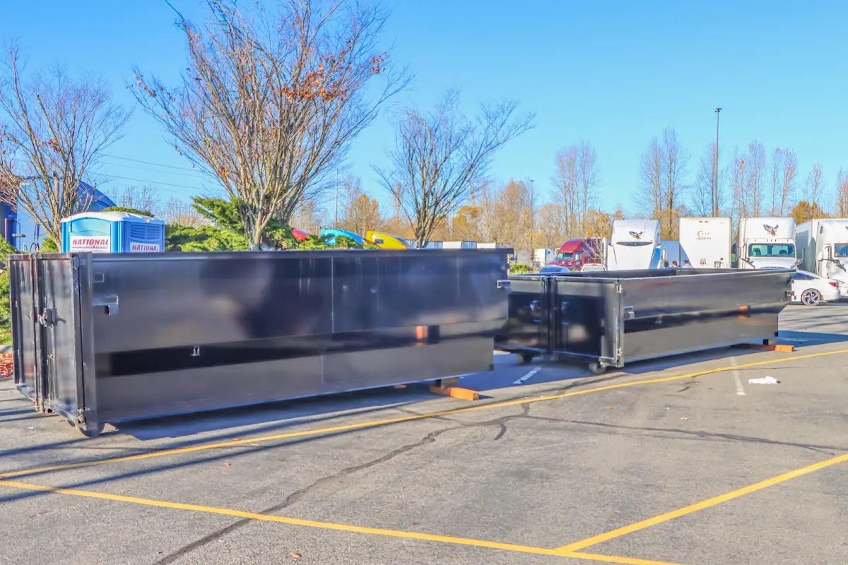 Professional dumpster rental service with roll-off container on residential driveway in Hondo